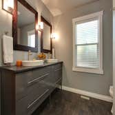 Bath White porcelain with glass tile. Shower features a bench and tray ceiling. Pedestal tub provides a timeless feel to the room.