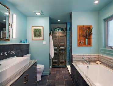 Moroccan Accent Bath The highlight of this bathroom are the two antique Moroccan doors that were affixed to a new custom cabinet. The doors were mounte