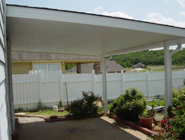 CARVER Insulated Patio Cover 4" insulated roof system with matching shingles. Extruded guttering system,downspouts and powder coated 14 guage post! Roo