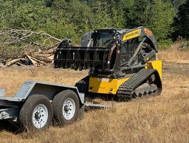 Skid steer with grapple attachment