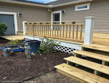 Custom Pressure-Treated Wood Deck Build with Railings in Holly Ridge, NC RGR Construction and Roofing, LLC recently completed a custom deck project for