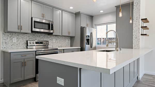 Modern countertops, new sink, cabinets and tile backsplash