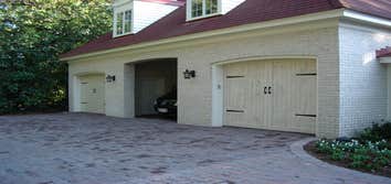 Carriage style doors First door (white with black hardware) is a stamped steel entry level door, second white painted custom door from Carriage House D