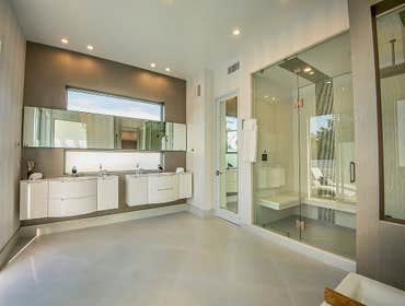 Spacious Modern Bathroom Design Experience the epitome of luxury in this master bathroom, featuring a his and hers shower head system for comfort and c