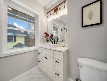 Photos by LCG BOSTON LLC #1 Full Home Remodel. Bathroom with custom glass, kitchen remodel with a beautiful exposed brick.