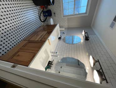 Smaller bathroom I remodeled tile 4’ around entire bathroom to the ceiling in shower and above vanity also floor tile