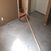 Basement leveling Westminster, CO Basement floor with 2-4 inches of drop, infilled and self-leveled out to perfectly level.
