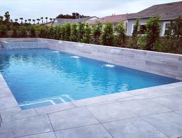 Photos by BP Water Concepts Inc #2 50' pool with a 8'x8' elevated spa. Raised Bond Beam covered in Wood Tile.