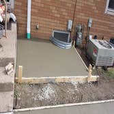 Sidewalk, patio extension, and ac pad Pour and finish sidewalk, patio extension, and ac pad.