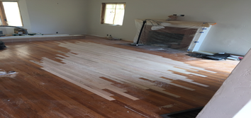 Solid Red Oak Repaired stained and damaged area with new 1/2" x 2" solid Red Oak. Sand and Finished 825sqft of new and old flooring natural color.