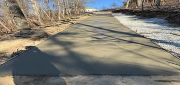 Photos by Ervin Investment Group, LLC #2 Remove old gravel. Excavate trench to install corrugated pipes for water drainage. Grade slope. Form and pour 