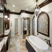 Lake House Master Bath Remodel This large lake house was originally built with builder-grade materials in the private areas of the home, which did not 
