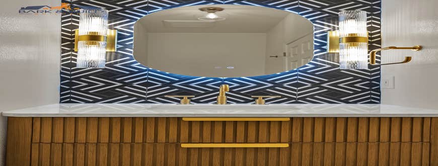 Mountain View, 3 Bathrooms A modern bathroom remodel featuring a custom walk-in shower with green vertical tile, frameless glass enclosure, and bru...