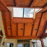 Custom Outdoor Living #1 Custom Hand Stacked Gable Roof with Full Glass Enclosure