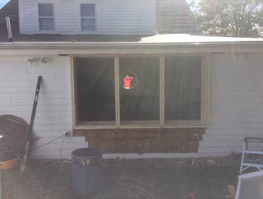 Bay window replacement in dennis Removed old leaking curved bay window, reframed opening for 3 new double hung windows side by side.