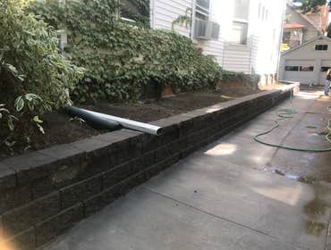 Expanded driveway and built a retaining wall block
