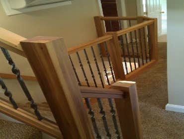 Custom carpentry Custom cedar and wrought iron railings
