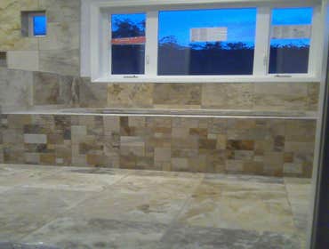 Master bathroom shower and tub deck and floor Interior master bath remodel. 16x16 chiseled edge travertine in shower and tub backsplash. Mosaic pattern
