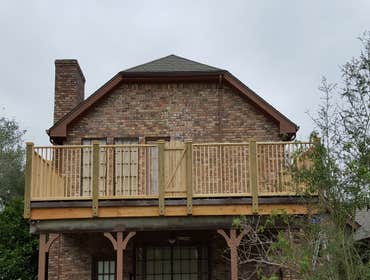 Dead On Decks 2nd story deck with custom railing and false door accent.