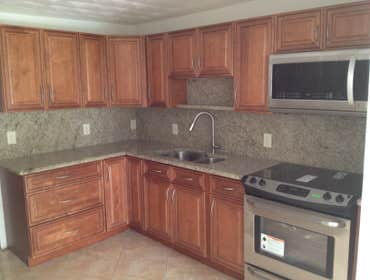 LOUBON KITCHEN kitchen renovation include all wood cabinetry and granite counter-top and backsplash .