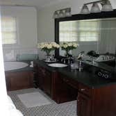 Guest Bath Handicap accessible full bath. originally built in 1950, this completely renovated bath is spacious with 3/4 height floor to ceiling tile,
