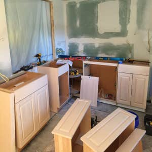 Complete 3 room remodel Bathroom, wash room, kitchen, mud room. Tile and wood flooring new cabinets relocation of laundry room custom hood vent