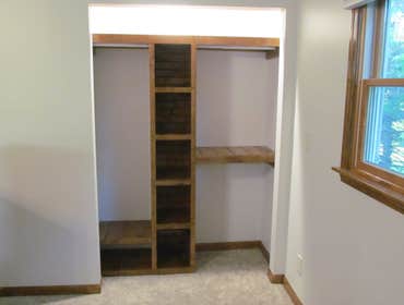 Photos by Banning Construction Inc #3 Knotty pine shelving with mirrored barn closet door.