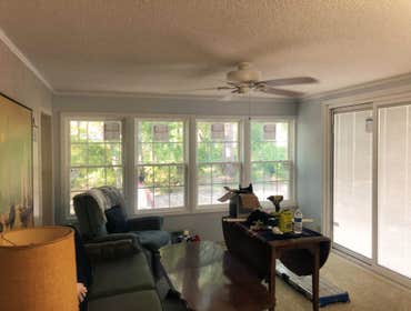 sunroom update removed old windows, sliding glass doors, and wall paneling, installed new windows, sliding glass doors, as well as sheet rock , new el