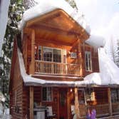 Log Home and Huge Shop This log home is set with 9 inch diameter turned cedar logs and framed dormer with cedar siding. It has a 12 by 24 log carport a