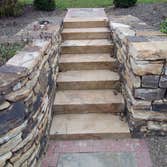 moore job this is outside stairs, seating area, sunk in play area with fire pit. intertaining area