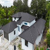Photos by Gold Star Miami Corp #1 metal roof panels all are . 25 years warrantee