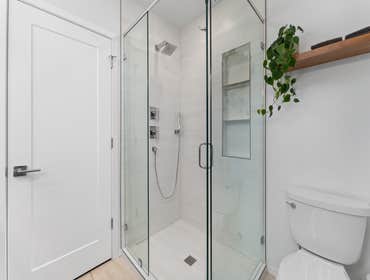 Kevin | Shower This shower remodel features new large-format porcelain tile with a soft, marble-look finish for a clean, timeless aesthetic. We install