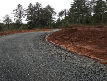 1/4 mile driveway install, house pad, and utilities This project consisted of re opening a existing logging road, re cutting slope, ditching, culverts,