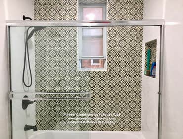 Kew Gardens Bathroom Reno The primary bathroom boasts a dual shower and tub combo, a shower with accent wall tile as a feature wall and then beautiful