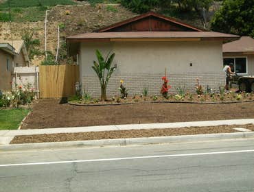 New home owner Installed complete irrigation system, bender board, seed, mulch, rock, fence and assorted flowers. We also planted trees on the upper em