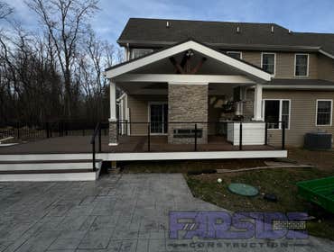 Photos by Farside Construction LLC #1 Newly constructed covered deck with standing seam cathedral style gable roof. Excavated and built a walk out egre