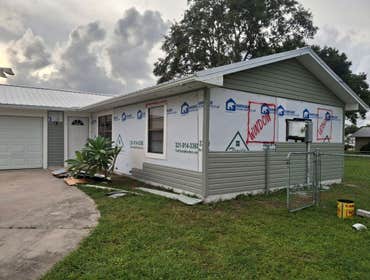 Photos by Florida Roofing and Renovations #1 Installing vinyl siding over and old T1-11 siding