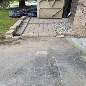 French drain with a stone walkway Client had water damage due to ground being unlevel allowing water to flow to the house. We leveled the ground built