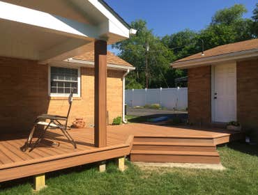 Covered back deck and side porch This beautiful backyard oasis includes a spacious deck which is partially covered by a 12 foot cathedral roof. This 