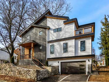 New Home Build in Arlington MA 1×4 fir soffit with modern styled two-tone siding • heated asphalt & cobblestone driveway with snowflake “auto-on” recog