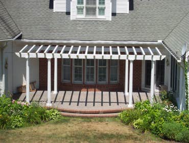 (2) Custom designed timber-framed pergola, timber-framed carport Each timber is hand carved to fit into the joining beam.