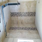 Photos by Demo & Renovation Services, LLC #3 Full master bathroom remodel. Relocated plumbing to accommodate new shower and tub location. Built new s