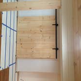 Basement finish in dennis Finished basement with new laminate flooring, knotty pine ceiling, and columns, knotty pine barn door, and half bathroom/laun