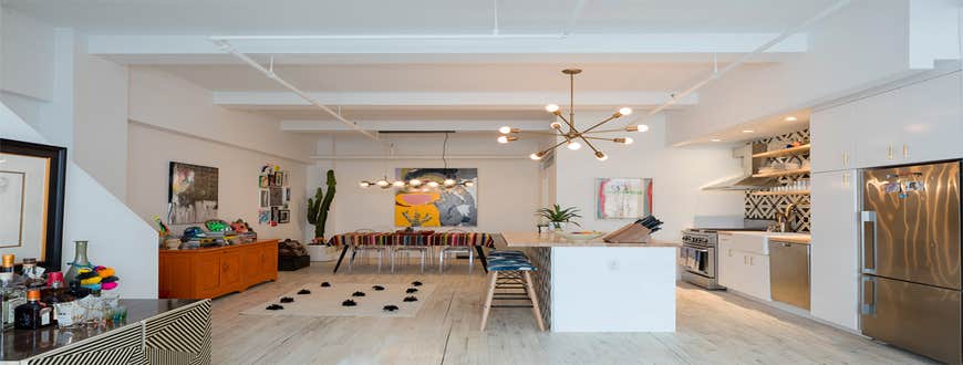 Silk Building Condo The one-bedroom, two-bath duplex had its main spaces opened through a reorientation of the kitchen’s storage. The dark oak floo...