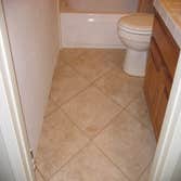 Project photos from RCL Construction Company, Inc Rich Springs Circle Project - Master bathroom with custom Alder cabinets, granite countertop, travert