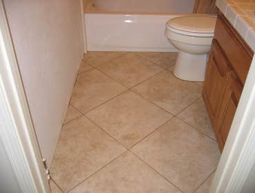 Project photos from RCL Construction Company, Inc Rich Springs Circle Project - Master bathroom with custom Alder cabinets, granite countertop, travert