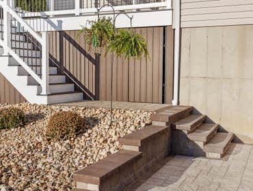 Photos by Iron Ridge Contracting LLC #2 Custom Deckorators deck with skirting, white vinyl railing and pergola and patio