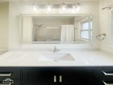 Reseda Bathroom Remodel We turned this Reseda bathroom into your sleek, modern haven! Imagine a black vanity with silver handles and a white quartz top