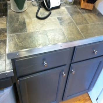 Lake Stevens Kitchen Remodel We installed a porcelain tile counter top and backsplash accented with aluminum strips and squares. Aluminum flat bar was