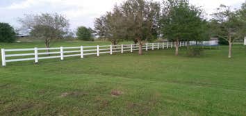 White Vinyl Fence Give us a call for all your fencing and custom entry needs. (337)532-3227.